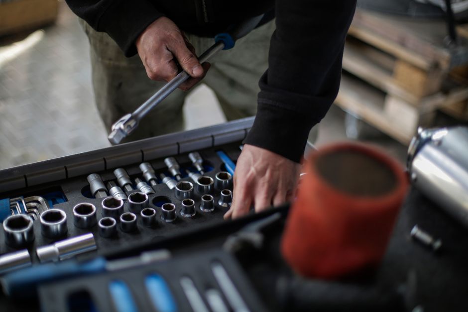 professional automotive technician working with precision tools and equipment